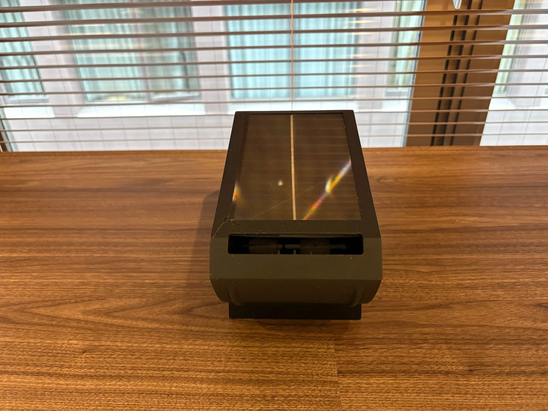 木目調のテーブルに置かれた黒い電子機器