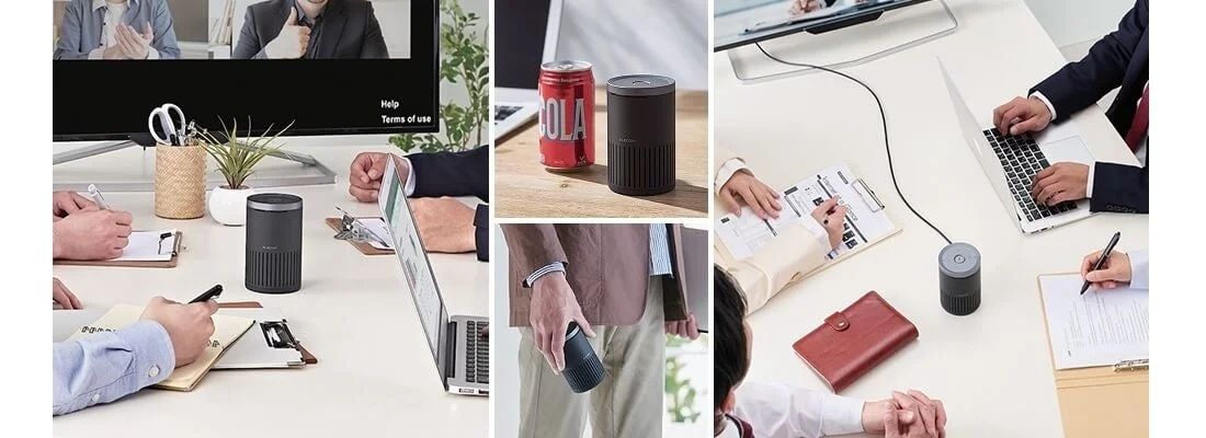 オフィスでWeb会議をする人々とスピーカーフォン