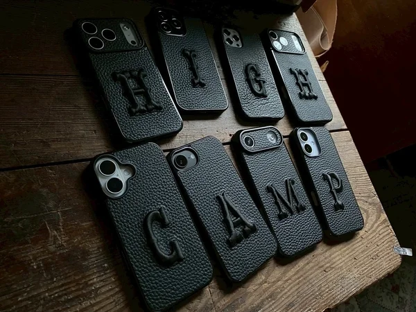 並べられたHIGH CAMPの文字が刺繍された黒い本革iPhoneケース