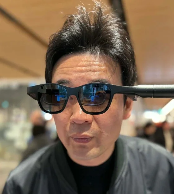 黒いスマートグラスを装着したアジア人男性のポートレート