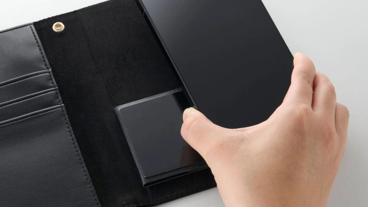 自己吸着シートにスマホを装着する様子