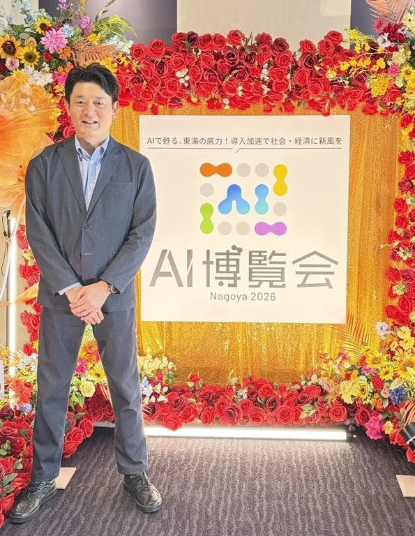 AI博覧会 Nagoya 2026のバナーの前で立つ主催者代表